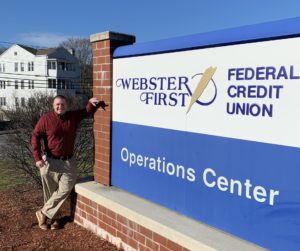 Webster First Federal Credit Union Vice President John Thomasian standing in front of Operations Center sign outdoors